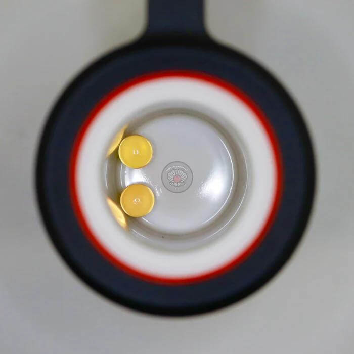 Close-up view of Ruby Pearl Co Yellow Sapphire Terp Pearls inside a dabbing rig, showcasing their vibrant color and design.