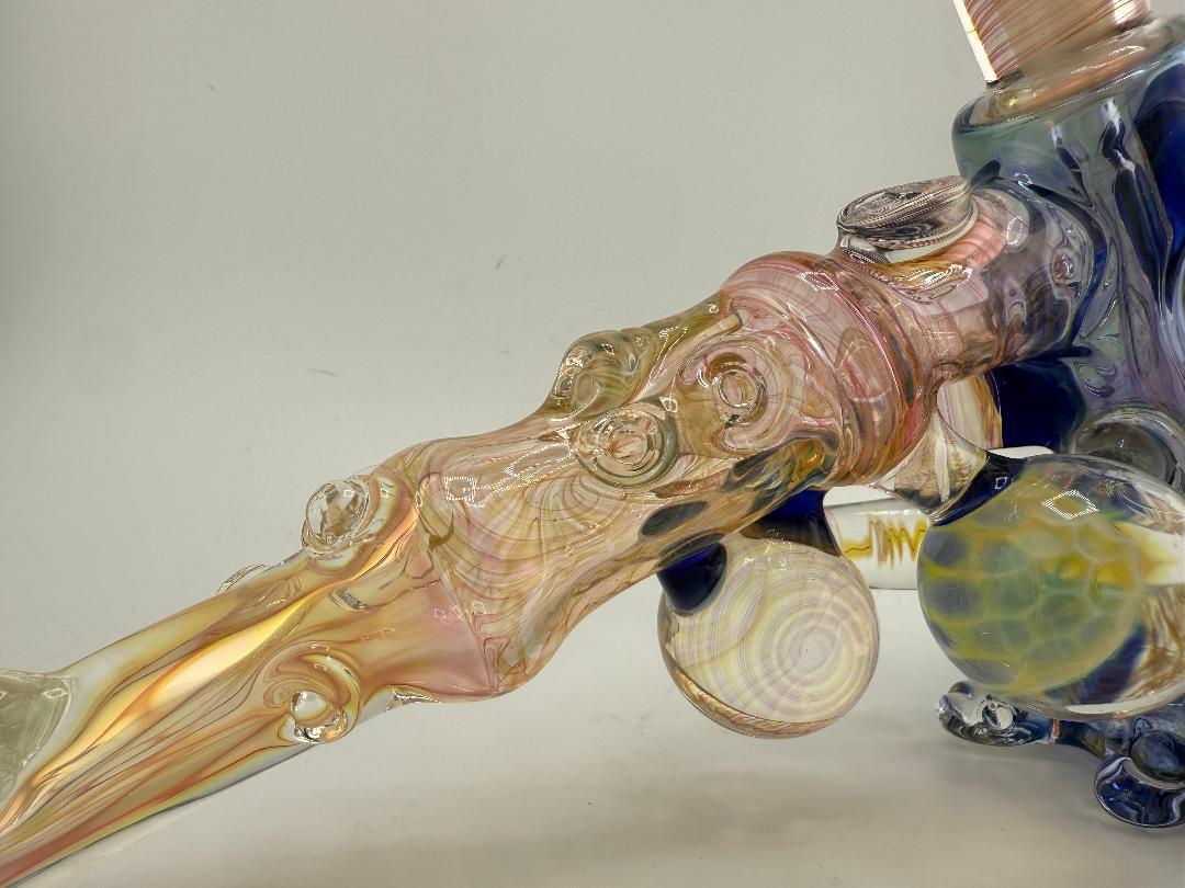 Close-up of Brando Glass Large Format Fumed Hammer with vibrant colors and intricate designs, showcasing its unique artistry and modern function.