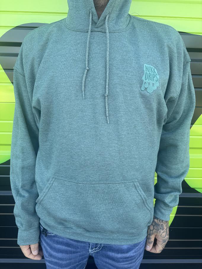 Nikk Drips Hoodie displayed on a model with a green background, showcasing its stylish design and comfort.