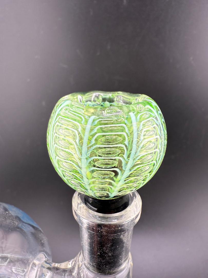 Close-up of a handcrafted Green Wrap & Rake 14mm bowl with vibrant green design and clear glass base.