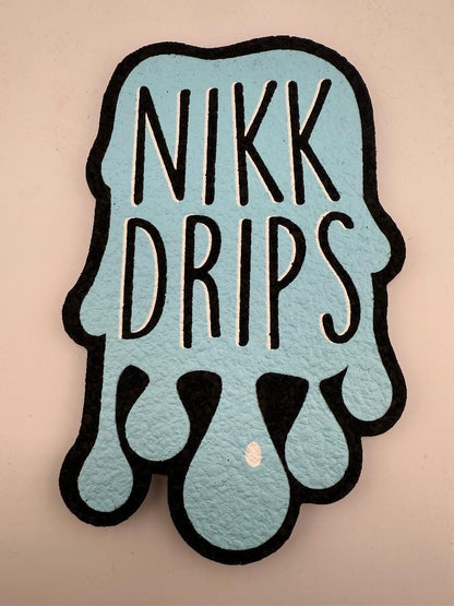 MoodMats x Nikk Drips Classic Logo Base Mat featuring blue splash design and bold lettering.