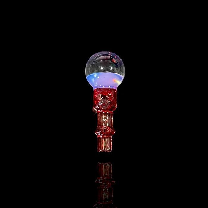 Tokr Glass Puffco Peak Accessory - Marble Joystick ( Coming Soon ) displayed on a black background with colorful lights.