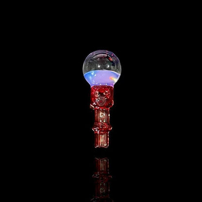 Tokr Glass Puffco Peak Accessory - Marble Joystick ( Coming Soon ) displayed on a black background with colorful lights.