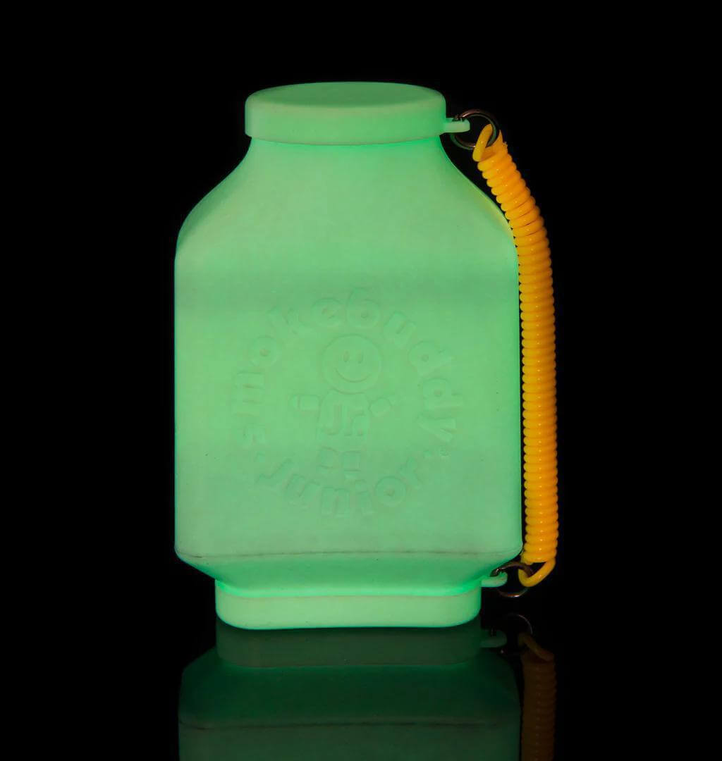 Smokebuddy Junior personal air filter glowing in the dark, compact design with yellow travel cap for discreet storage.
