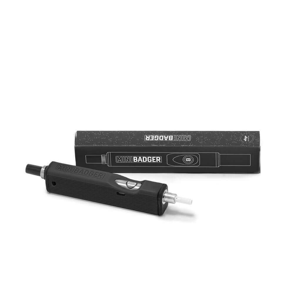 Huni Badger Mini device next to its box, showcasing compact design and portability for discreet use.