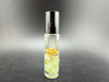 Crystal perfume roller bottle with gemstone rollerball and essential oil, showcasing aromatherapy and crystal healing.