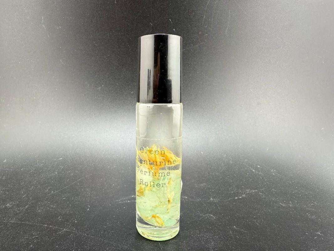 Crystal perfume roller bottle with gemstone rollerball and essential oil, showcasing aromatherapy and crystal healing.