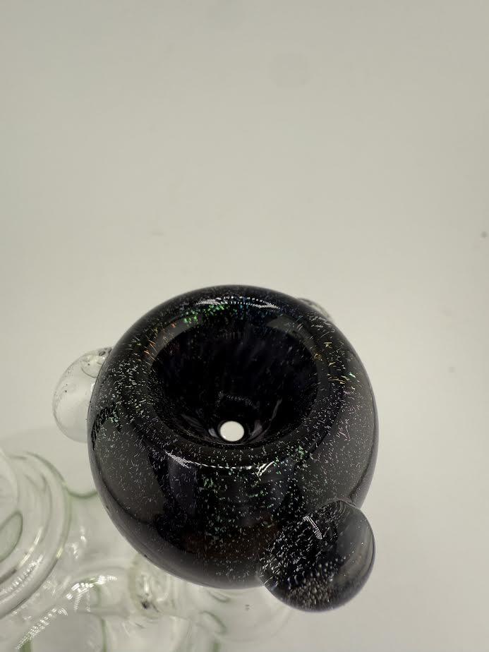 Close-up of Glass Distractions dichro push bowl piece made of black borosilicate glass, showcasing a shiny, modern design.