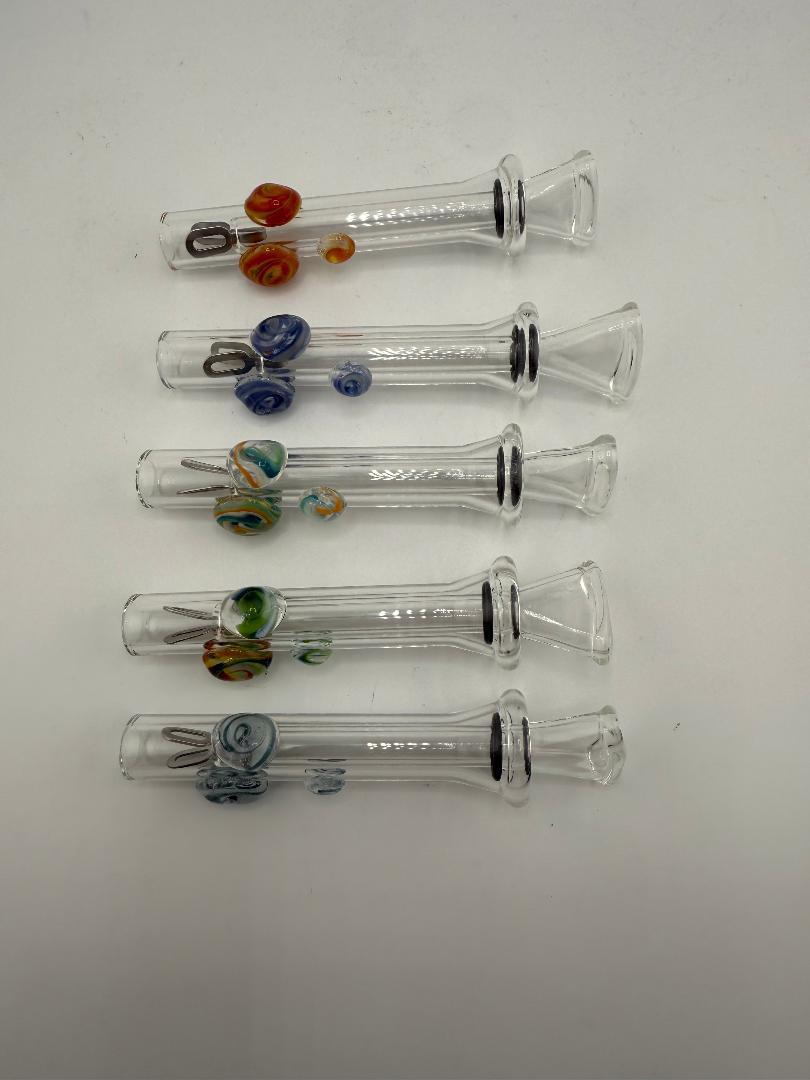 Collection of handcrafted home blown glass sliders with colorful accents in various designs.