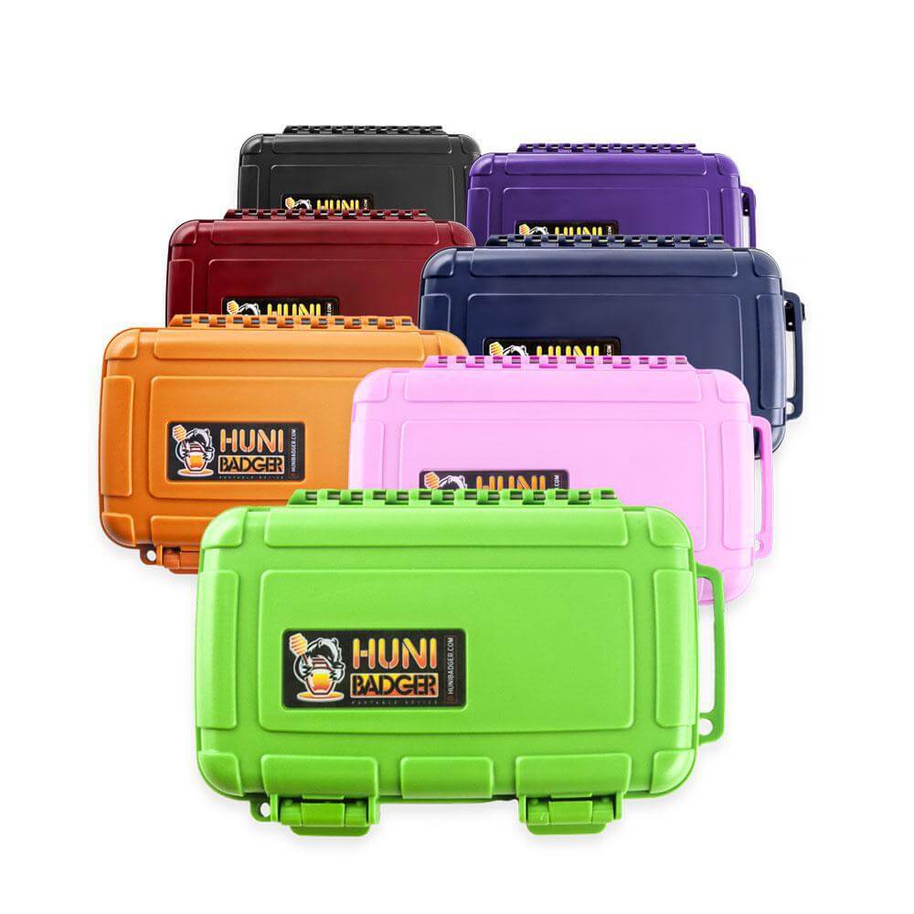 Colorful Huni Badger portable cases in various hues, perfect for on-the-go herbal extract consumption.