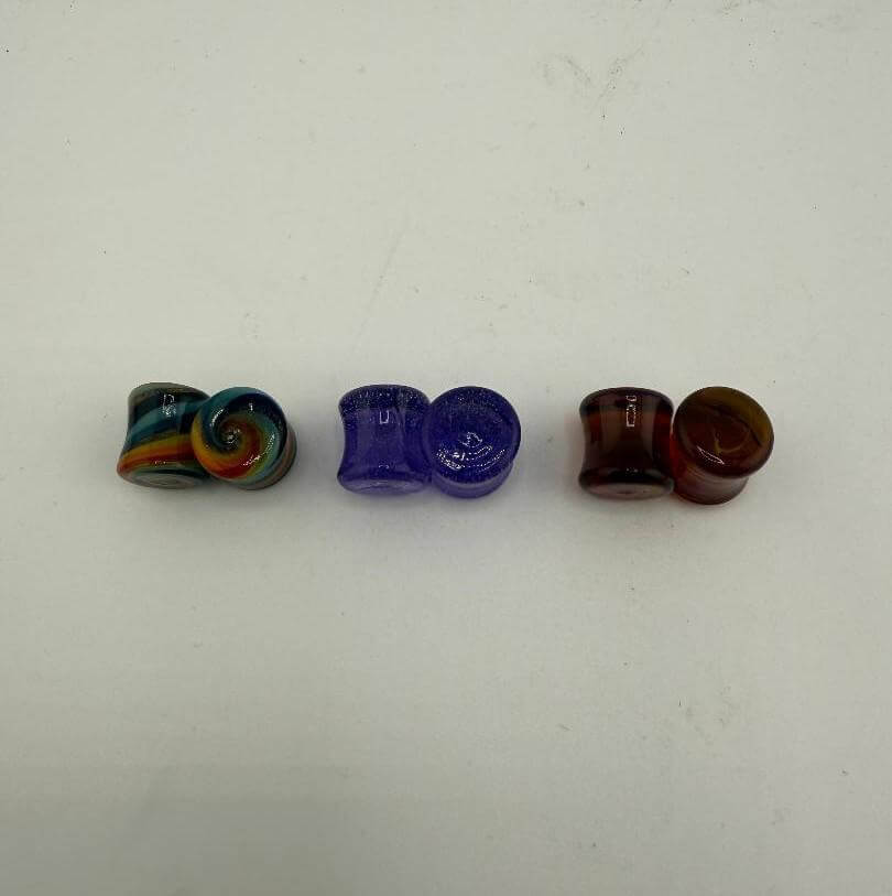 Colorful Paulson Pieces 9mm ear plugs in borosilicate glass, showcasing unique designs and vibrant hues.
