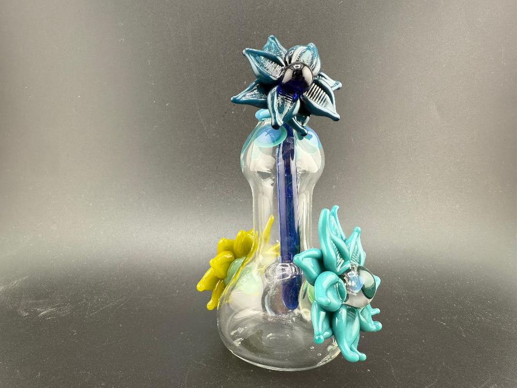 Pablos Glass Flower Jar featuring colorful glass flowers in blue and yellow on a clear base, perfect for decorative use.