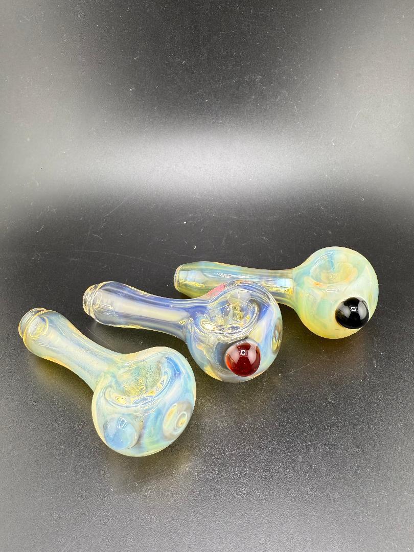 Highgrade glass hand pipes with fumed finish and colorful accents, showcasing a sleek, minimalist design.