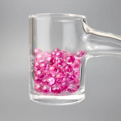 Ruby Pearl Co Pink Sapphire Terp Pearls in a dab rig for optimized dabbing and flavor enhancement.