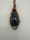 Fluid Central wire-wrapped labradorite pendant showcasing natural beauty and artistry, perfect for grounding energy.