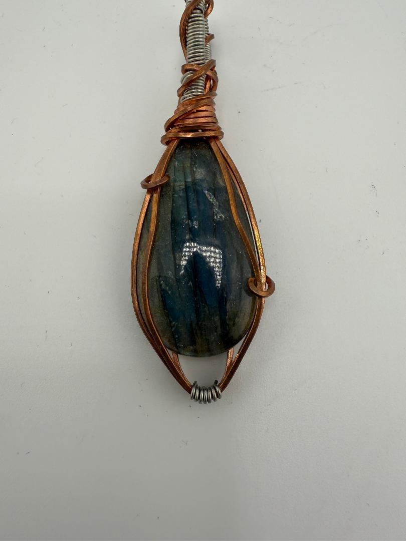 Fluid Central wire-wrapped labradorite pendant showcasing natural beauty and artistry, perfect for grounding energy.