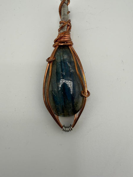 Fluid Central wire-wrapped labradorite pendant showcasing natural beauty and artistry, perfect for grounding energy.