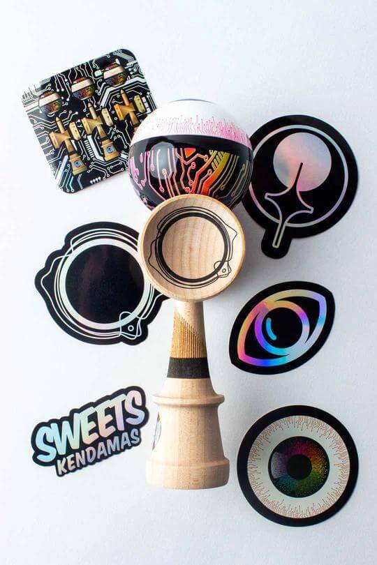 Sweets Kendama Subtronics V2 - Amped with colorful tama and various stickers on a light background.