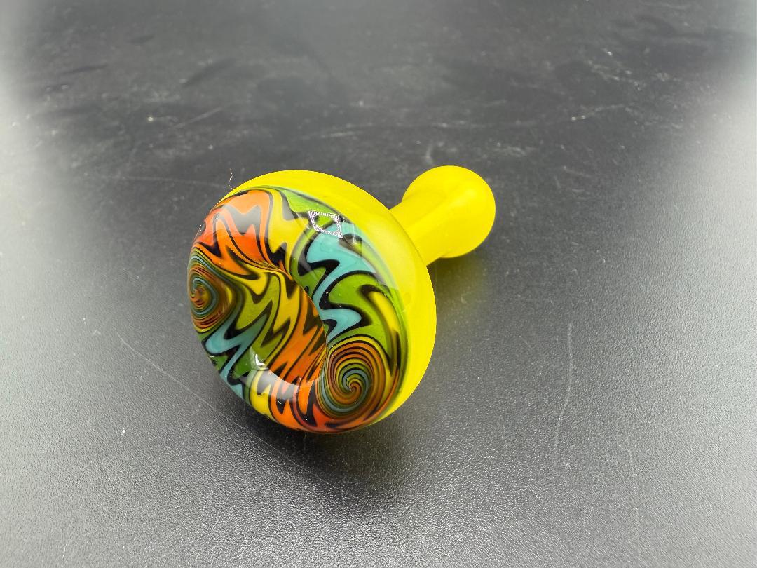 Mcdoogle Glass Chillum with vibrant yellow base and colorful swirl design, handcrafted in Spokane, WA.
