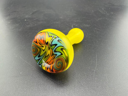 Mcdoogle Glass Chillum with vibrant yellow base and colorful swirl design, handcrafted in Spokane, WA.