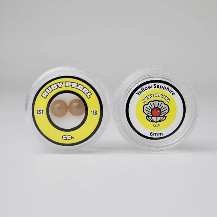 Ruby Pearl Co Yellow Sapphire Terp Pearls in packaging, premium lab-grown sapphire for dabbing.