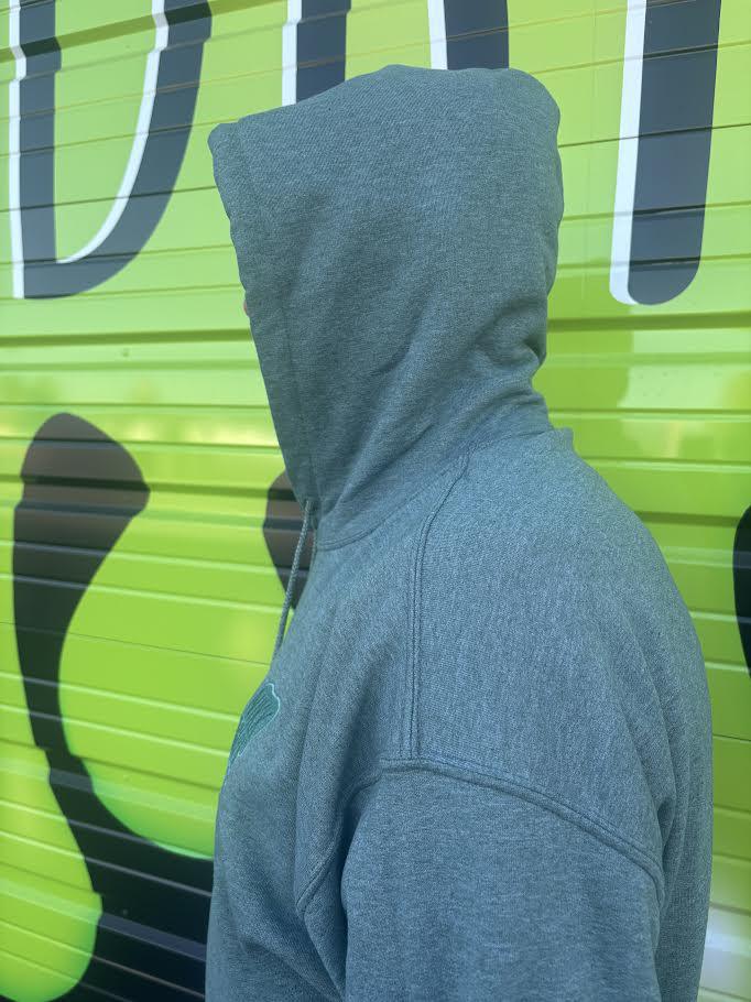 Nikk Drips Hoodie shown in profile against a colorful background, highlighting its stylish hood and fabric.