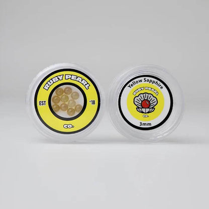 Ruby Pearl Co Yellow Sapphire Terp Pearls in packaging, featuring lab-grown yellow sapphires for dabbing.