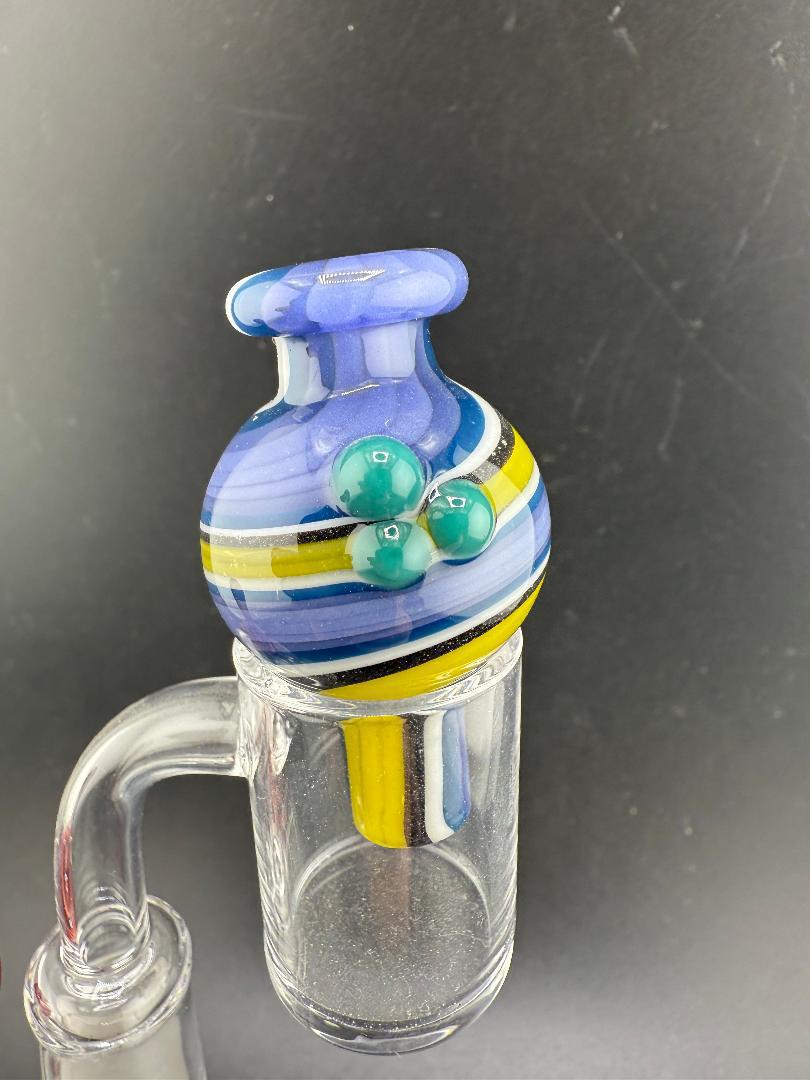 Filla John Line Worked Bubble Cap with colorful blue and yellow stripes, featuring green accents for enhanced dabbing performance.