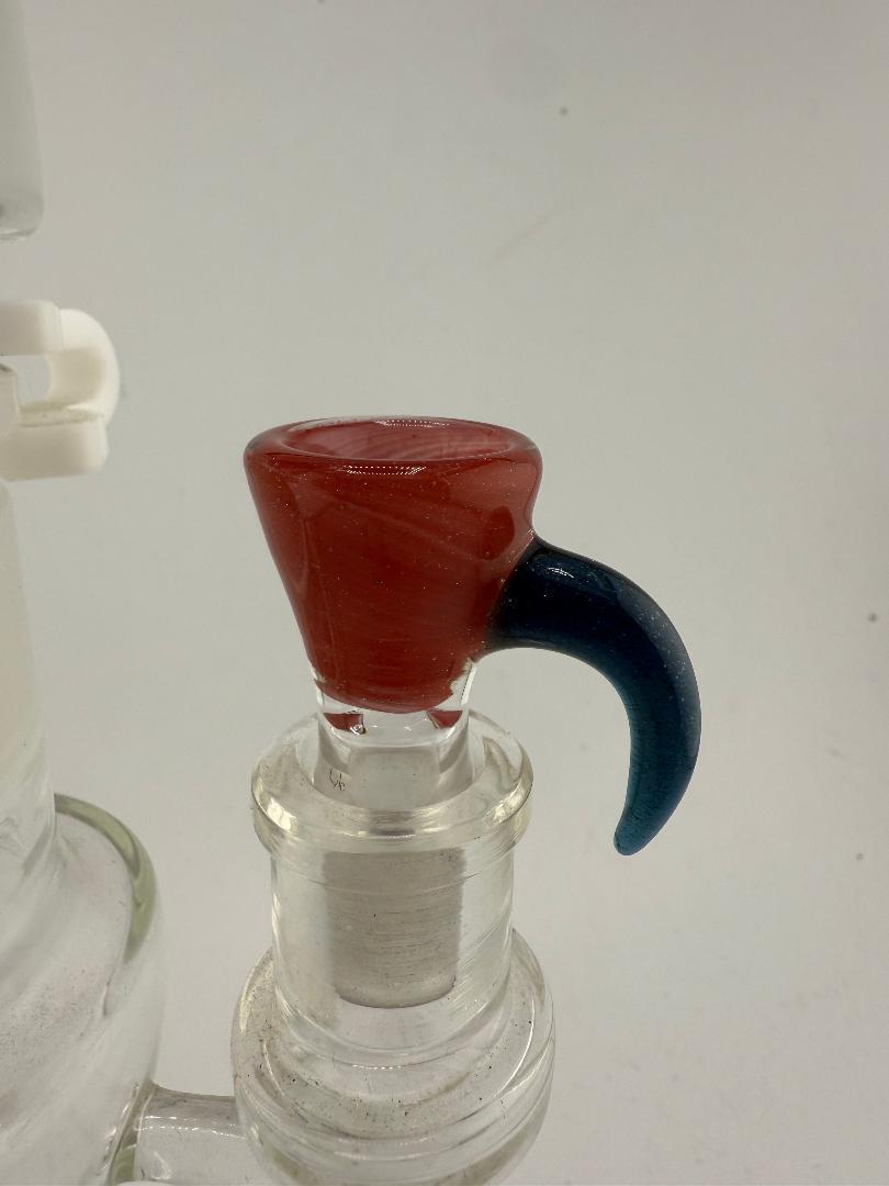Close-up of Lylo Glass martini bowl with red and blue accents, featuring single-hole design for smooth airflow.