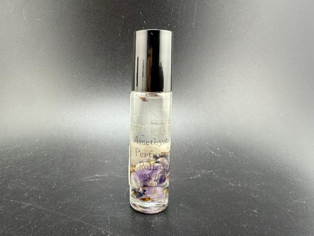 Amethyst crystal perfume roller filled with essential oil, promoting aromatherapy and gemstone energy.