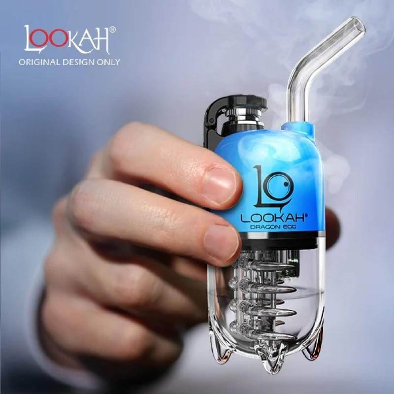 LOOKAH Dragon Egg electric dab rig held in hand with smoke, showcasing its unique design and portable size.