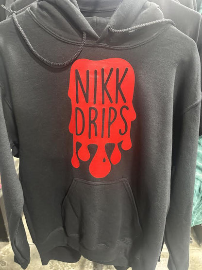 Nikk Drips Hoodie with Vinyl Logo displayed on a hanger, featuring bold red logo and spacious front pocket.