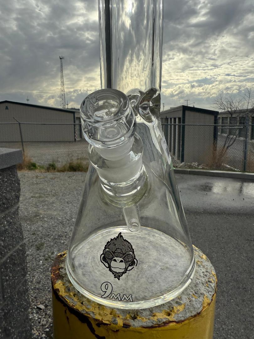 AFM Glass "18 Clear Beaker Flower Piece Red AFM Logo 14mm 45° displayed in outdoor setting with clear glass.