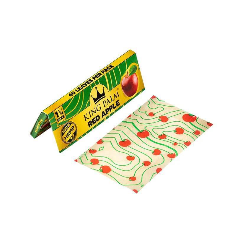 King Palm Red Apple flavored hemp rolling papers 1 1/4 size with packaging and leaf design.