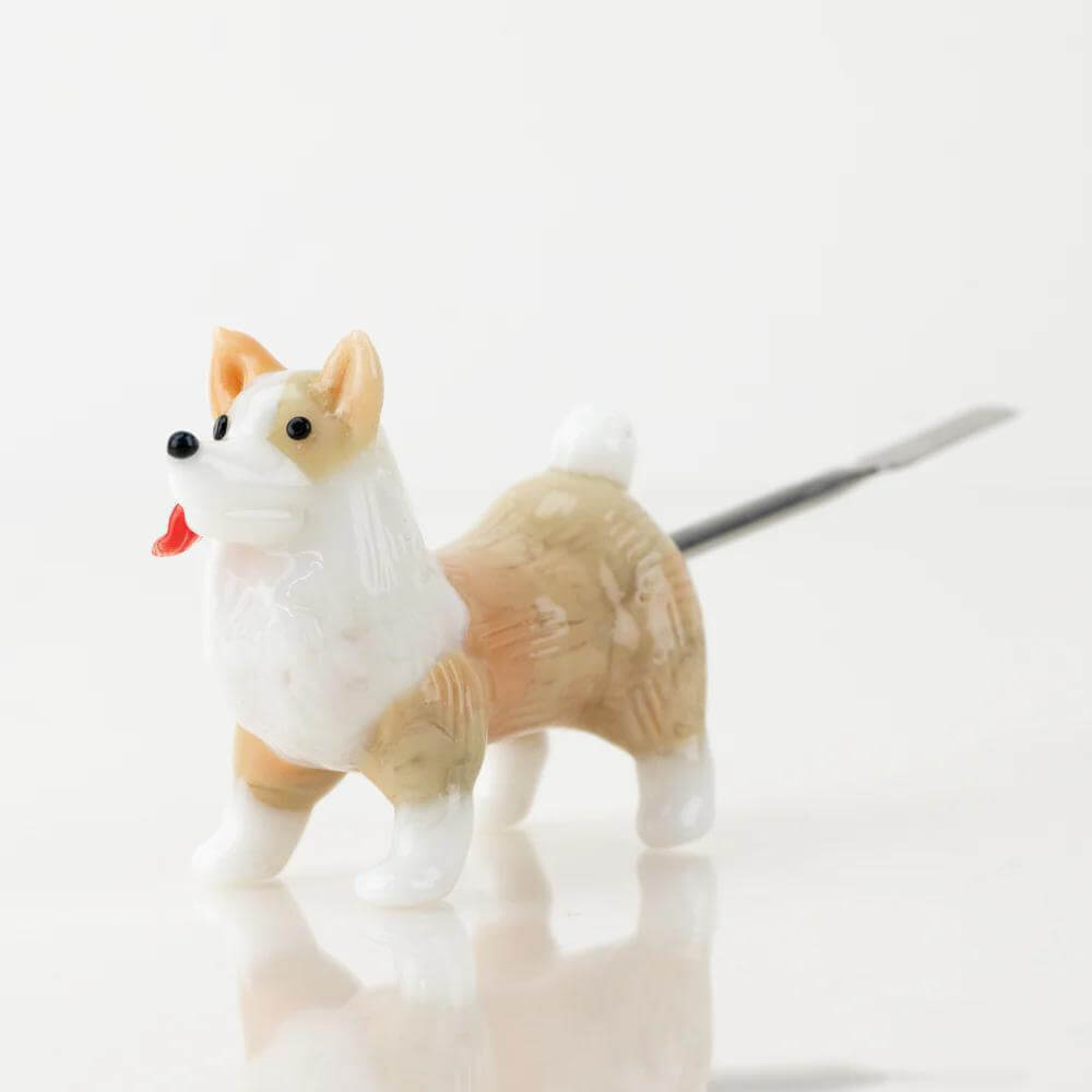 Empire Glassworks Dab Tool featuring a playful corgi design in borosilicate glass with a titanium tip.