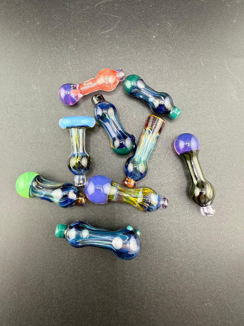 Colorful assortment of handcrafted glass accessories, including the Paulson Pieces Puffco Peak Pro Ball Cap Replacement.