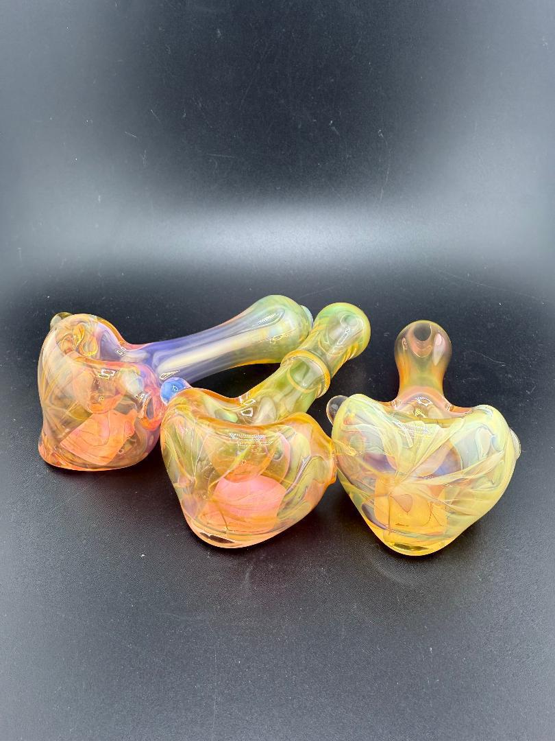 Handcrafted Elbow Tim Glass Fumed Pipes showcasing vibrant color-changing fumed finish, made in Spokane, WA.