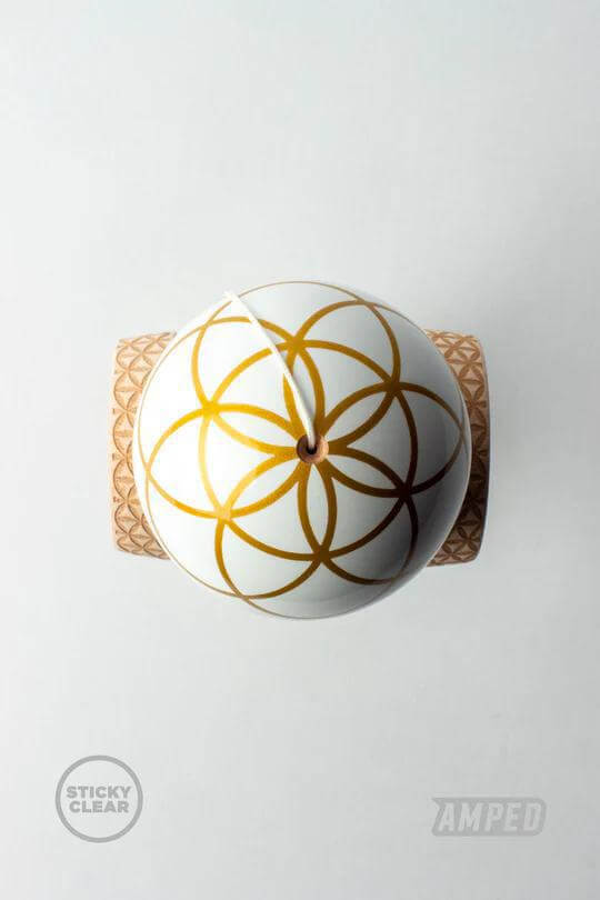 Top view of Sweets Kendama - Johnny Raekes - Amped, showcasing its unique design with gold patterns.