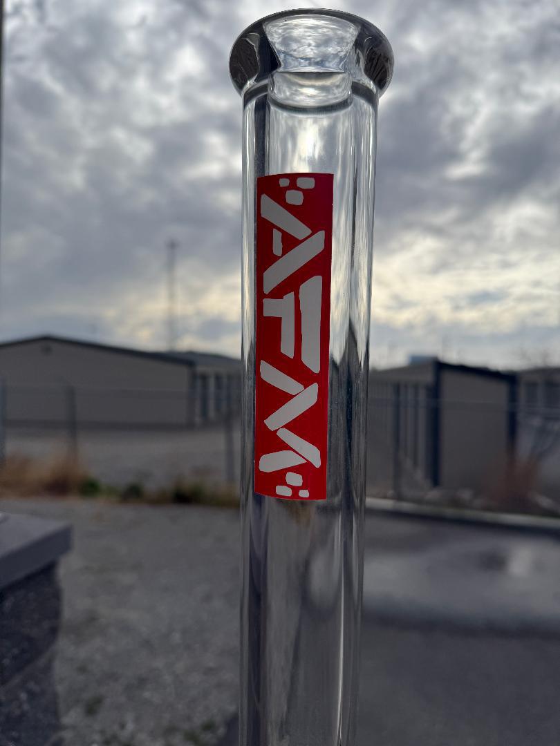 AFM Glass "18 Clear Beaker Flower Piece Red AFM Logo 14mm 45° - close-up of red AFM logo on clear glass.