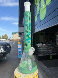 AFM Glass 18" Quasar Glass Leaf Flower Beaker 14mm 45° showcased outside with vibrant green design.