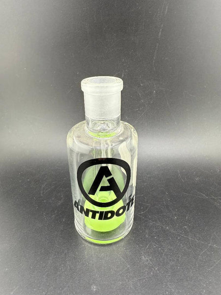 Antidote Glass 14mm 90° Color Ash Catcher with green accents and logo on borosilicate glass.