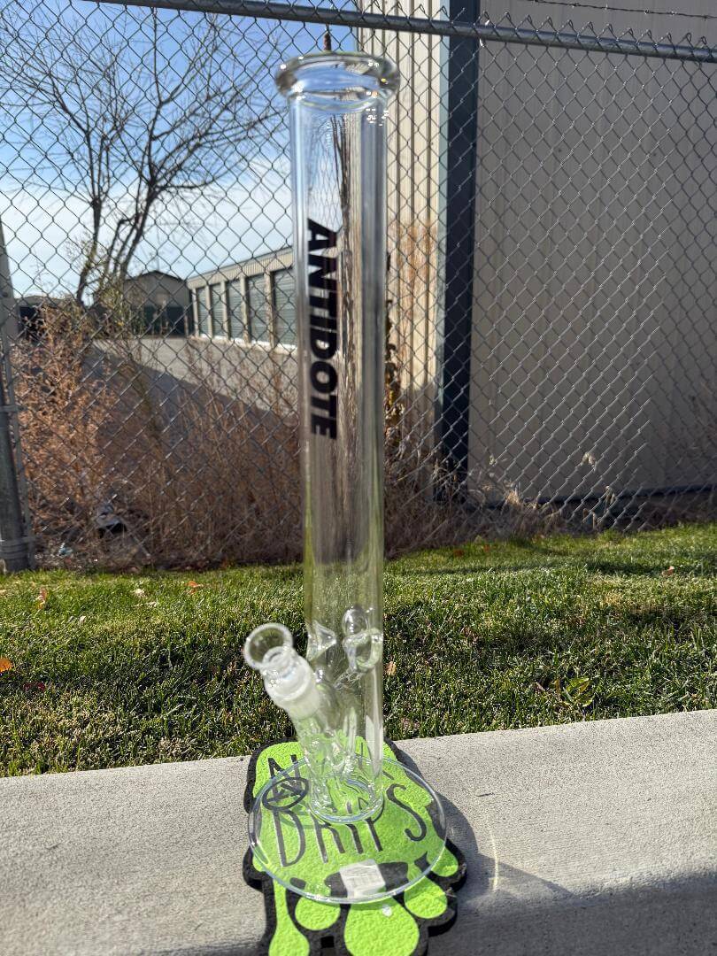Antidote Glass 18" Ripper Straight Tube 15mm 45° displayed outdoors on a colorful base with a black logo.