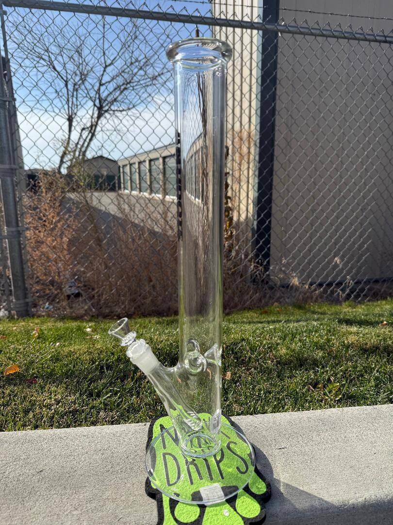 Antidote Glass 18" Ripper Straight Tube 15mm 45° displayed outdoors on a colorful mat.