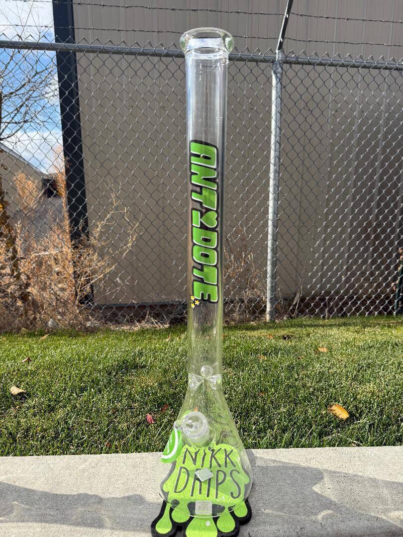 Antidote Glass 24" Beaker 14mm 45° - Powerpuff displayed outdoors with vibrant green color and fun design.