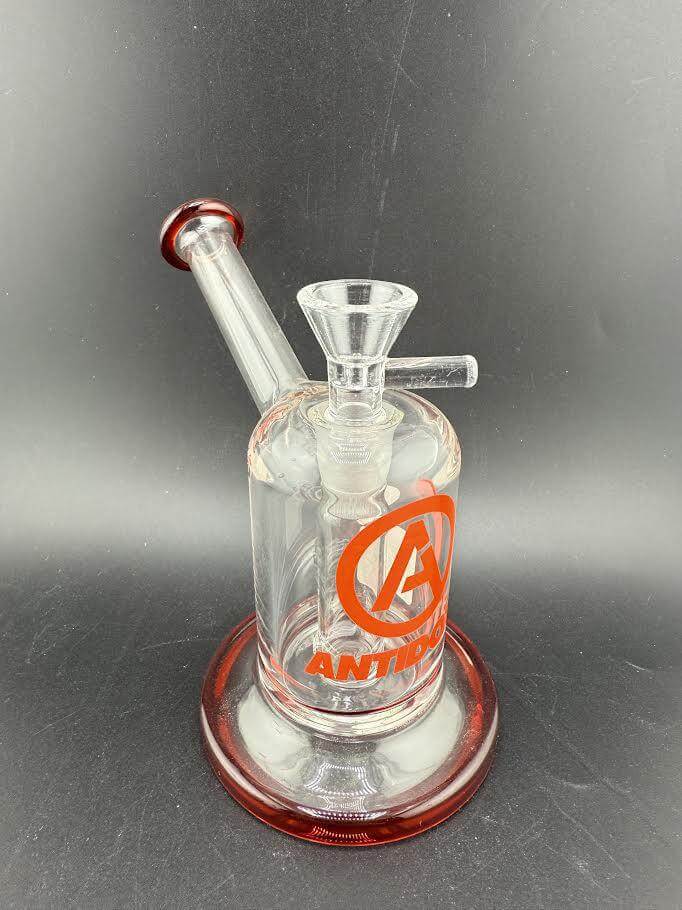 Antidote Glass Capsule Rig 14mm 90° in clear glass with red accents and logo, designed for smooth airflow and filtration.