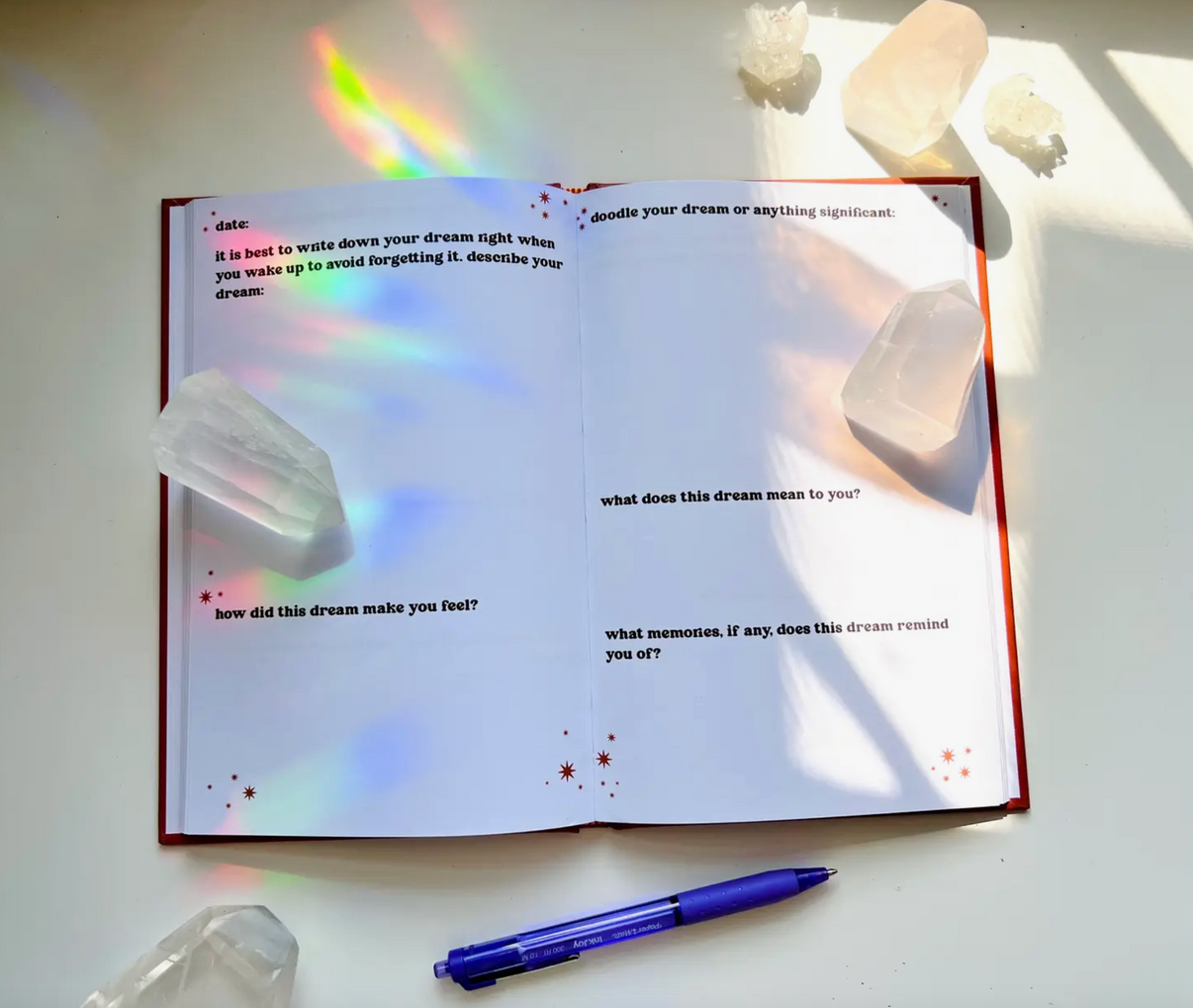 Ark Made Dreamers Guided Journal open to pages with prompts and crystals for mindful journaling.
