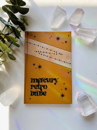 Ark Made Mercury Retro Babe Lined Journal on a bright background with crystals and greenery.