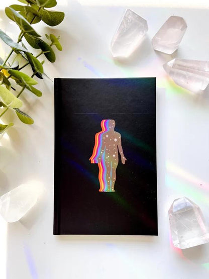 Ark Made The Self Lined Journal on a table surrounded by crystals and greenery.