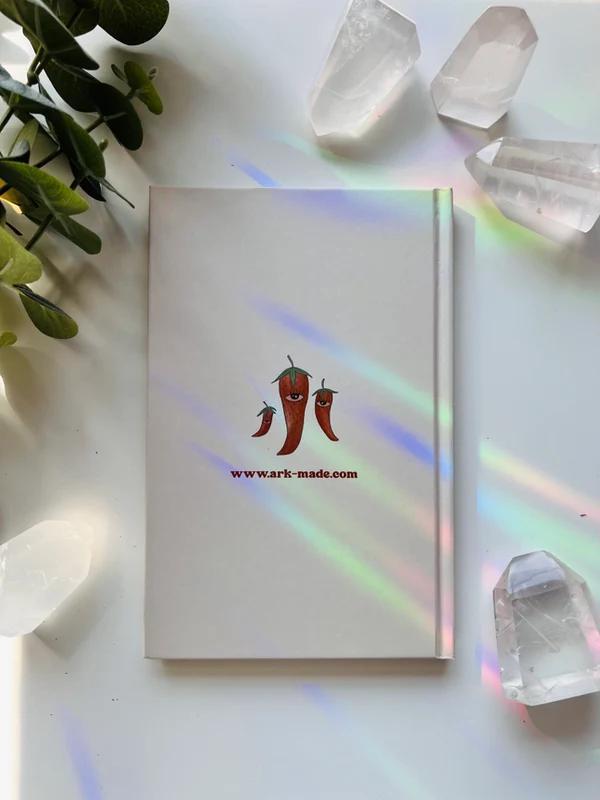 Ark Made Spicy Lined Journal featured with crystals and greenery on a light surface.