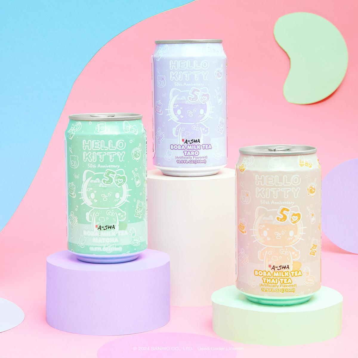 A-Sha Hello Kitty 50th Anniversary Boba Milk Tea cans displayed on pastel pedestals.